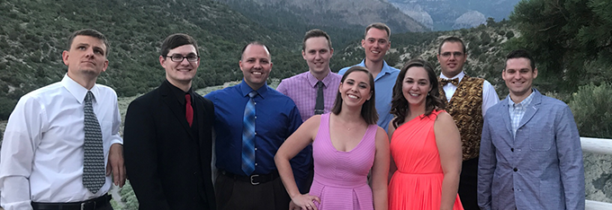 Residents posed at a railing Family Medicine Residency (FMR) residents posed against a railing with hillsides behind